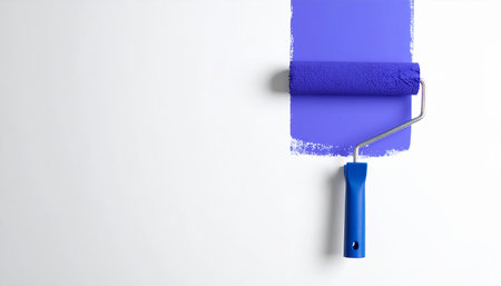 Roller with blue paint on a white background, top view.の素材