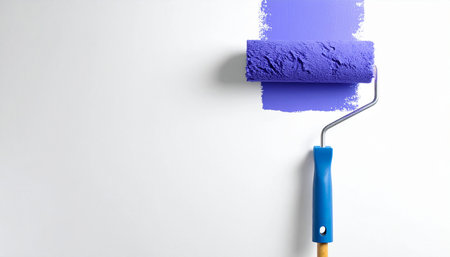 Paint roller with blue paint on a white background, copy spaceの素材