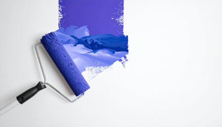 Paint roller with blue and purple paint on white background. Top viewの素材