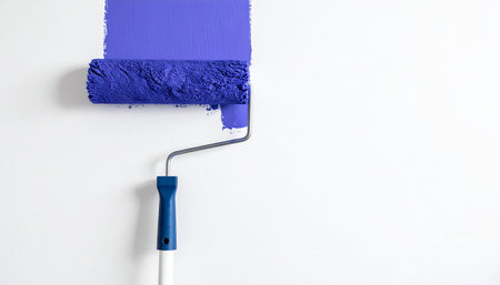 Paint roller with blue paint on a white background. Copy spaceの素材