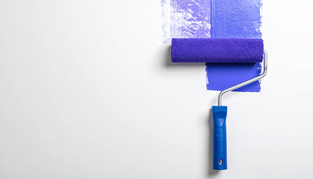 Roller with paint on white background, top view. Space for textの素材