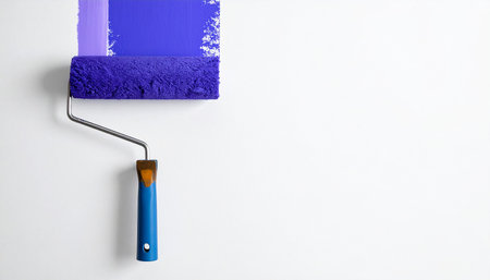 Paint roller with blue paint on a white background with copy spaceの素材