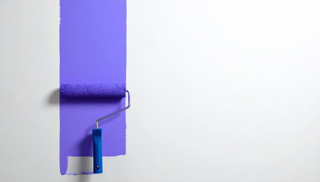 Paint roller on a white wall with copyspace for textの素材