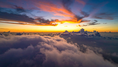 Aerial view above the clouds at sunset. Beautiful nature background.の素材