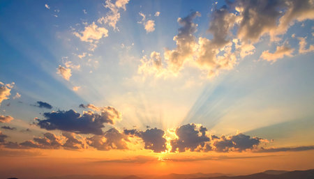 Sunset sky with clouds and sun rays. Beautiful nature background.の素材