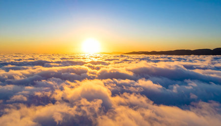 Beautiful sunset above the clouds. Aerial view of clouds at sunsetの素材