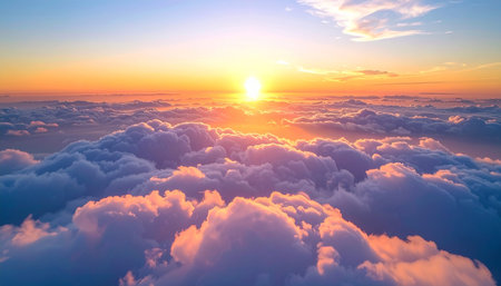 Beautiful sunset above clouds. Aerial view above clouds at sunset. View from airplane window.の素材