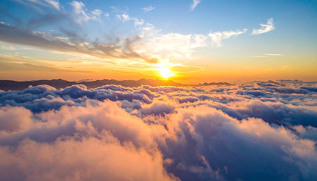 Beautiful aerial view above the clouds at sunset. Nature background.の素材
