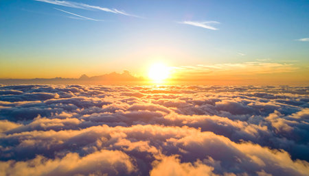 Beautiful sunrise above the clouds in the sky. Nature background.の素材