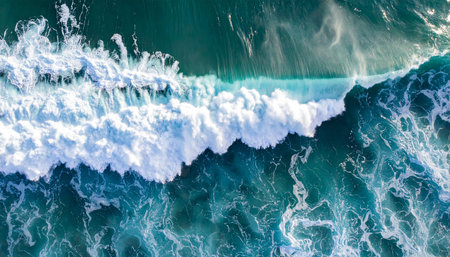 Aerial view of blue ocean waves with white foam and splashesの素材