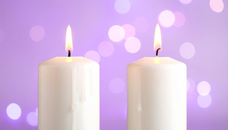 Burning candles on purple background, closeup. Space for textの素材