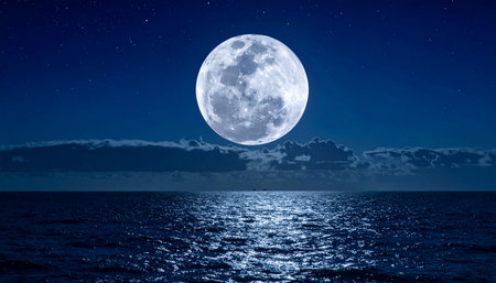 Full moon over the sea at night with starry sky and cloudsの素材