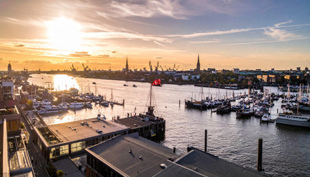 Hamburg harbor with numerous sailboats and industrial cranes during golden hour. Clear details and vibrant colors enh...の素材