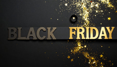 Black Friday text with gold glitter stars and confetti scattered on a dark surface.の素材