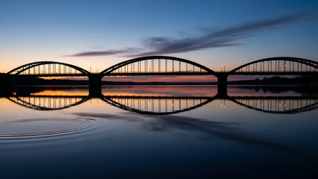 Sunset over the bridge across the river with reflection in the waterの素材