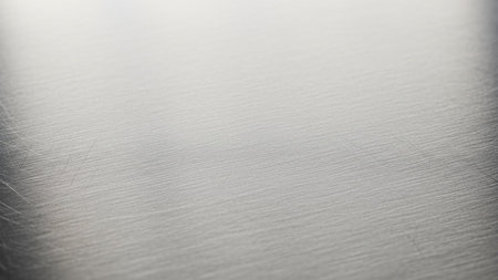 Brushed metal surface closeup. Abstract background and texture for design.の素材