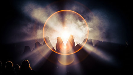 Silhouettes of people at concert in front of bright stage lightsの素材