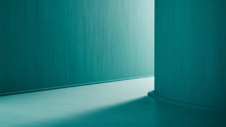 An abstract architectural interior is depicted with smooth, seamless walls painted in a striking teal hue. The space is defined by clean lines and gentle curves, with a floor that meets the walls at a sharp angle. A soft, diffused light emanates from an unseen source, casting gentle shadows and highlighting the subtle variations in the wall's texture. The perspective draws the viewer into the scene, suggesting a pathway or corridor leading towards a brighter, illuminated area. The overall...の素材
