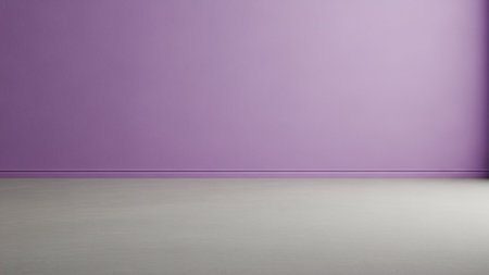 A minimalist interior scene is depicted with a smooth, solid lavender-colored wall meeting a light gray concrete floor. A subtle shadow line is visible where the wall meets the floor, indicated by a thin, darker gray baseboard. The lighting is soft and diffused, creating a clean and serene atmosphere. The overall aesthetic is simple, modern, and uncluttered, offering a neutral yet inviting backdrop.の素材