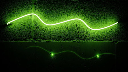 A single, vibrant green neon tube forms a smooth, undulating wave across a dark, textured concrete wall. The bright light of the neon stands in stark contrast to the rough, shadowed surface, creating a visually striking and minimalist composition. The reflection of the light can be seen subtly on the lower portion of the wall, adding depth and a sense of ambient illumination.の素材