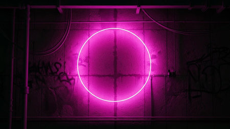 A striking, bright pink neon circle glows intensely against a dark, textured concrete wall. The wall is adorned with graffiti, adding an urban and edgy feel. Industrial pipes and wires are visible, further contributing to the gritty, atmospheric setting. The contrast between the vibrant neon light and the dark, rough background creates a visually impactful and modern abstract composition. The evokes a sense of contemporary and urban nightlife.の素材