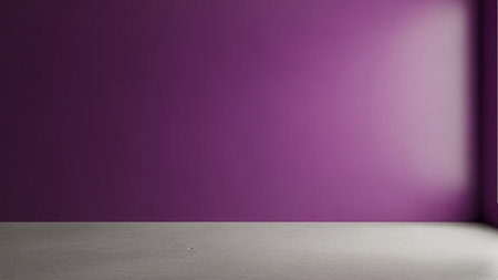 An uncluttered and minimalist interior scene featuring a single, large wall painted in a deep, vibrant shade of purple. The opposite wall and a portion of the floor are visible, rendered in a neutral, textured concrete grey. The lighting creates a soft gradient across the purple wall, with a brighter area in the upper right corner suggesting a light source from an unseen window or fixture. The floor is flat and matte, providing a grounded contrast to the bold color of the wall. The overall...の素材
