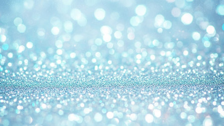 A soft focus background filled with numerous small, sparkling blue and white light particles creating a bokeh effect. The foreground has a denser concentration of glitter, suggesting a surface covered in fine, shimmering The overall impression is ethereal and magical, with a gentle, diffused light. The colors are predominantly cool blues and whites, creating a serene and festive atmosphere.の素材