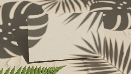 A blank, textured off-white paper card is centrally placed on a soft beige, crinkled fabric background. Dramatic shadows from tropical palm and fern leaves are cast across the card and surface, creating a natural and organic aesthetic. The composition is clean and minimalist, offering ample copy space for or presentation.の素材