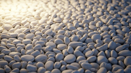 A dense arrangement of smooth white pebbles illuminated by a bright light, forming a textured, abstract pattern.の素材