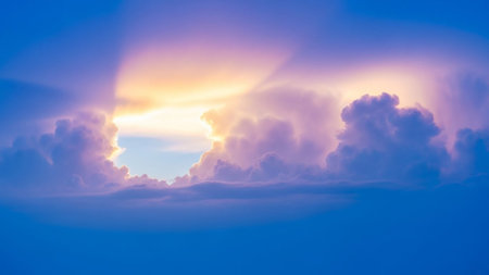 A dramatic sky filled with soft purple and orange clouds, through which golden sun rays are breaking over a deep...の素材