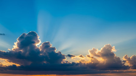 20251228 showing dramatic sunset sky with sun rays breaking through dark cumulus clouds. resolutionの素材