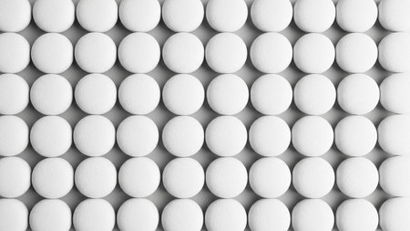 A symmetrical arrangement of numerous white, round pills or tablets displayed in neat rows and columns on a plain...の素材