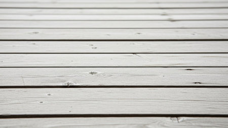 Close-up of light grey wooden deck planks laid horizontally, showing natural wood grain and knot details with a...の素材