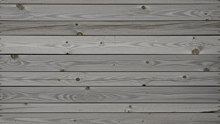 Planks showing weathered grey wooden planks with visible knots and grain patterns forming a horizontal surface.の素材