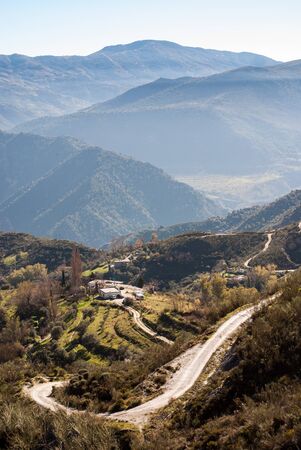 Mountain landscape with a curved road on a sunny day