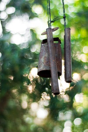 Rusty wind chime on a green backgroundの写真素材