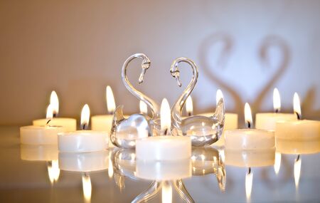 candles in the shape of a heart with swansの写真素材