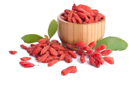 barberries near goji berries heap and bowl with goji isolated on white backgroundの写真素材