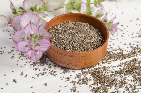 Chia seed healthy super food with flower over white wood background. Salvia hispanica.の写真素材