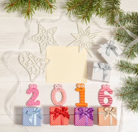 composition from numbers 2016 and gift boxes on wooden table
