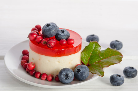 fruitcake with berries in porcelain saucer