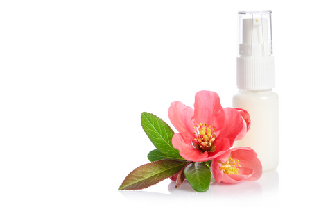 Face cream bottle with pink flower isolated on whiteの写真素材