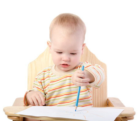 A boy draws with a pencil , isolated on white backgroundの写真素材