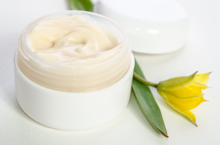 Jar of beauty cream with cap with tulipsの写真素材