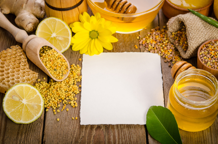 beekeeping products on a wooden table with empty card for you text . top viewの写真素材