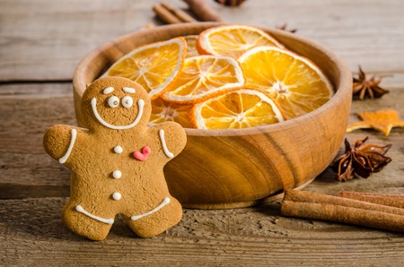 Christmas decoration with oranges and gingerbread on wooden background.top view