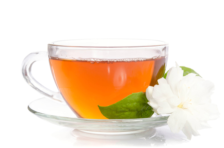 Glass cup of Tea with jasmine flowers and leaves isolated on white backgroundの写真素材