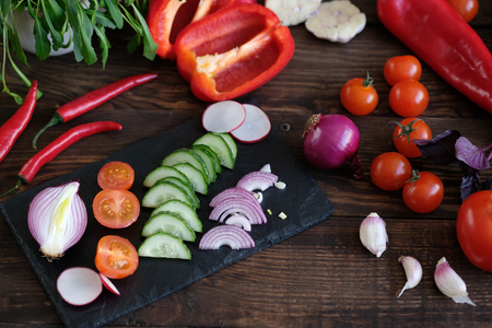 vegetables for salad on an old wooden table.の写真素材