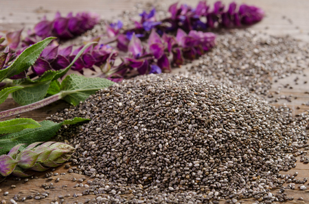 Chia seed healthy superfood with flower over wooden tableの写真素材