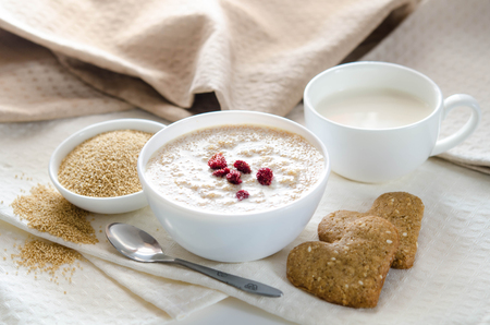 Healthy breakfast. Sesame dry cookies in the form of heart porridge of amaranth with strawberries and yogurt.の写真素材